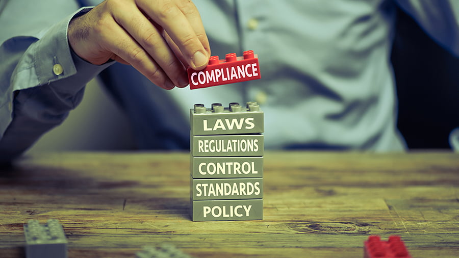 Business Compilance Stack of lego bricks with: compliance, laws, regulations, control, standards and policy
